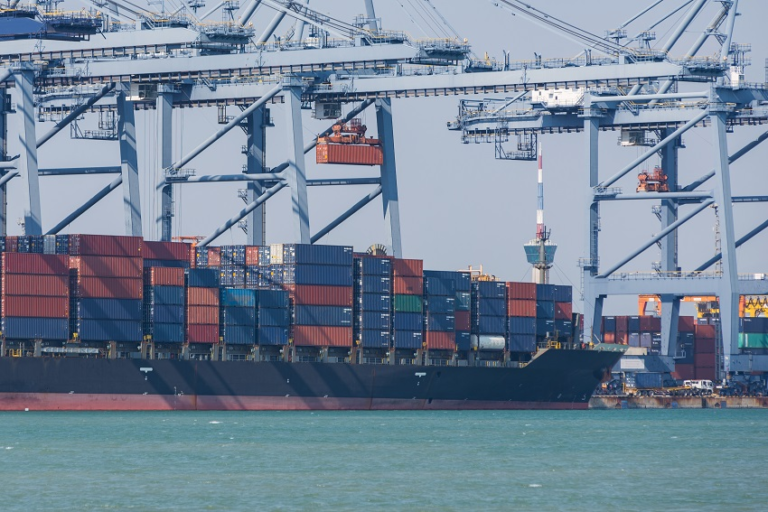 Large dock cranes unloading a large cargo ship