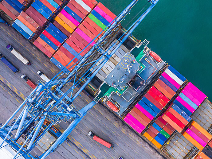 Overhead view of dock crane unloading containers from a cargo ship