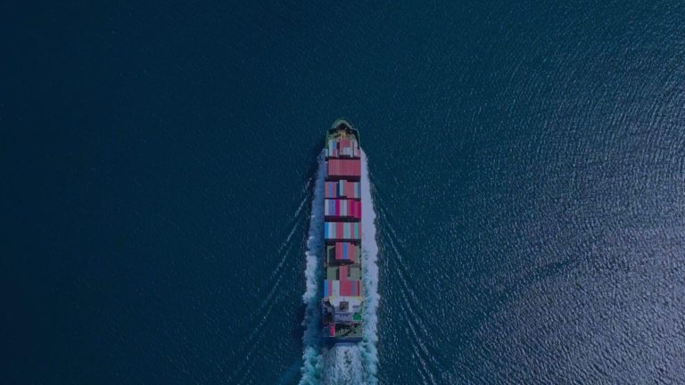 Aerial view of a loaded container ship in the open ocean